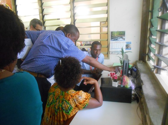 Dr Fabian Ndenzako Team Leader – Communicable Disease of WHO points out to DATA Entry Clerks at Begabari Clinic vital information they are collecting.