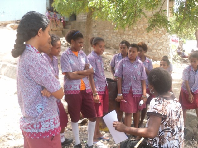 Issabella Warre Coordinator of the Anglciare Water Sanitation adn Hygiene Program conducting a Focus Group Discussion with senior students of the Koki Primary School, October 2014 