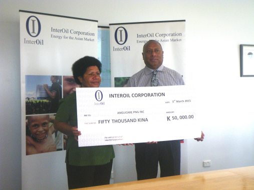Anglicare PNG Inc. National Director Mrs. Heni Meke receives th Dummy Cheque of K50,00.00 from the Mr. Isikeli Taureka Executive Vice President for InterOil, March 3rd 2015, Port Moresby. PNG
